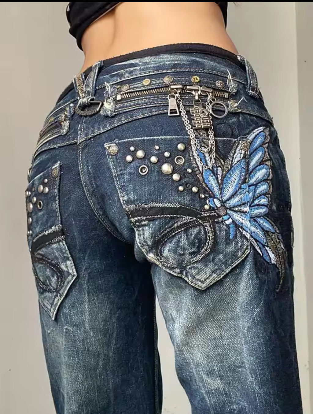 Blue butterfly embellished jeans with silver hardware