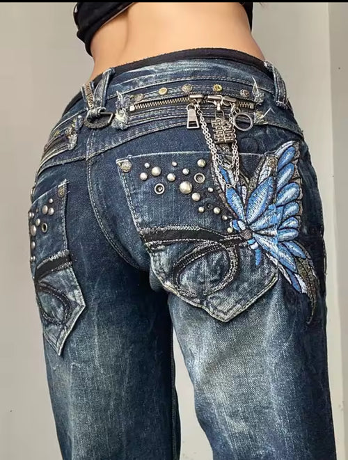 Blue butterfly embellished jeans with silver hardware